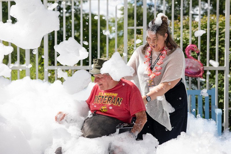 Residents at the Menlo Park Veterans Home enjoy a foam machine at the home's end-of-summer celebration.